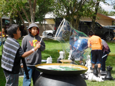 Photo courtesy of Indian Wells Elementary SchoolIndian Wells Elementary School students Karl Turtle and Larrance Begay attempt to make the largest bubble they can at the Navajo County Fair.