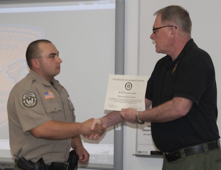 Photo courtesy of NPCNavajo County Sheriff K.C. Clark (right) presents a Meritorious Service Award to NPC’s Northeastern Arizona Law Enforcement Training Academy (NALETA) Recruit Krystopher Sanchez (left).