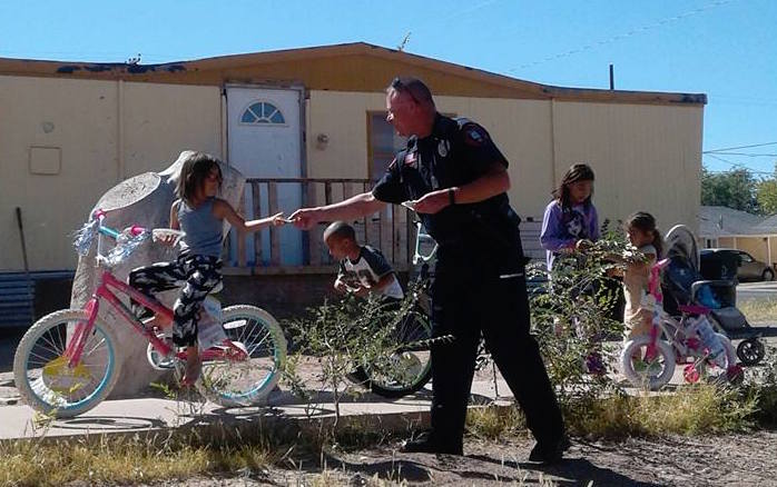 Photo by Jamie McPhersonA generous Holbrook citizen who chose to remain anonymous made a number of unsuspecting children very happy earlier this month when she purchased four new bicycles and asked Lt. Jack Arend (pictured here) of the Holbrook Police Department to find children who might appreciate them. Arend said he drove around town for about an hour until he saw these kids playing outside sharing a scooter and knew he’d found the ones they should go to.