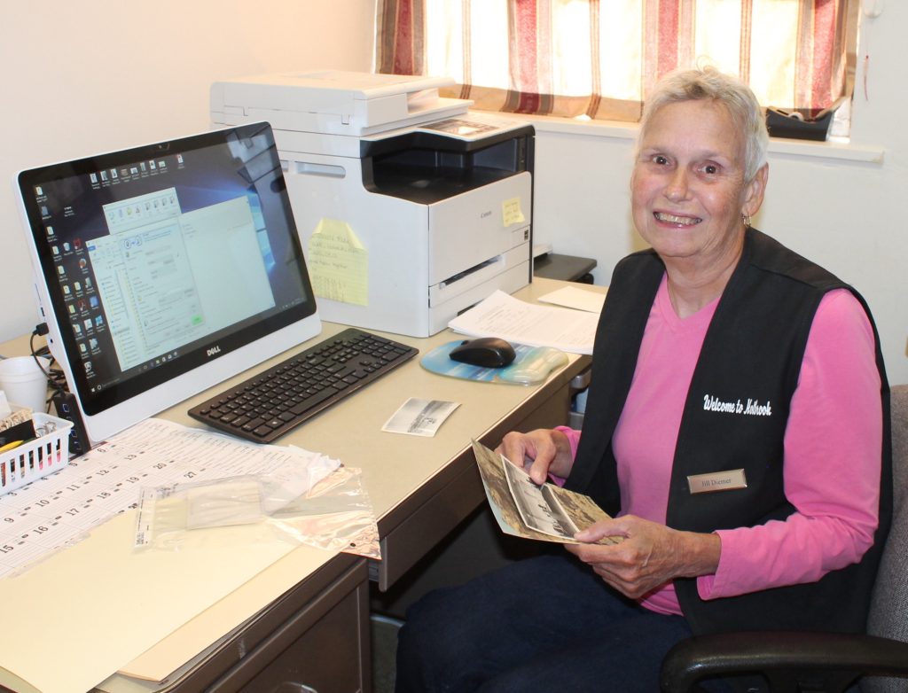 Photo by Linda KorVolunteer Jill Diemer works to sort, identify and input information on the thousands of photographs housed at the museum.