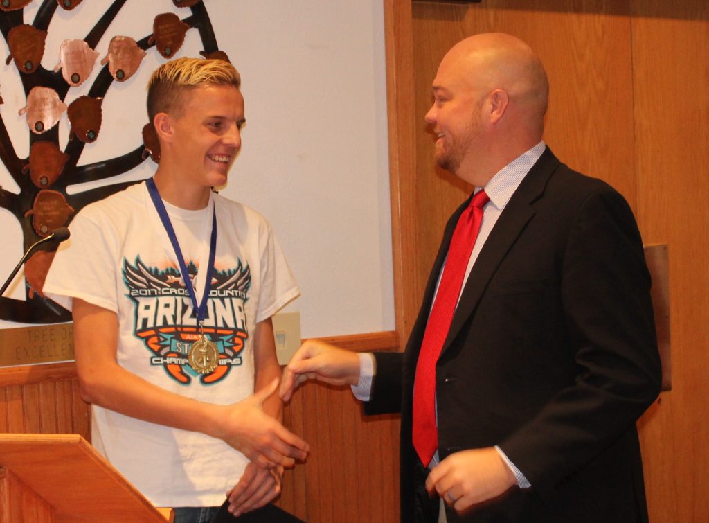 Photo by Toni GibbonsTalon Smith (left), a junior from Joseph City High School, was presented a certificate of recognition by Supervisor Jason Whiting (right) at the Navajo County Board of Supervisor’s meeting on Nov. 28. The certificate was given in honor of Talon winning first place in Division 4 cross country at the 2017 Arizona Interscholastic Association State Cross Country Tournament on Nov. 4, with a time of 16:39.