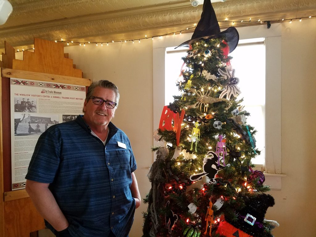 Photo by L. ParsonsWinslow’s Festival of Trees was a tremendous success this year with 60 entries auctioned to provide approximately $2,500 for the Winslow Chamber of Commerce to fund fireworks, the Little League and local promotion. Here CEO Bob Hall poses with a tree decorated by Winslow Prison Complex.