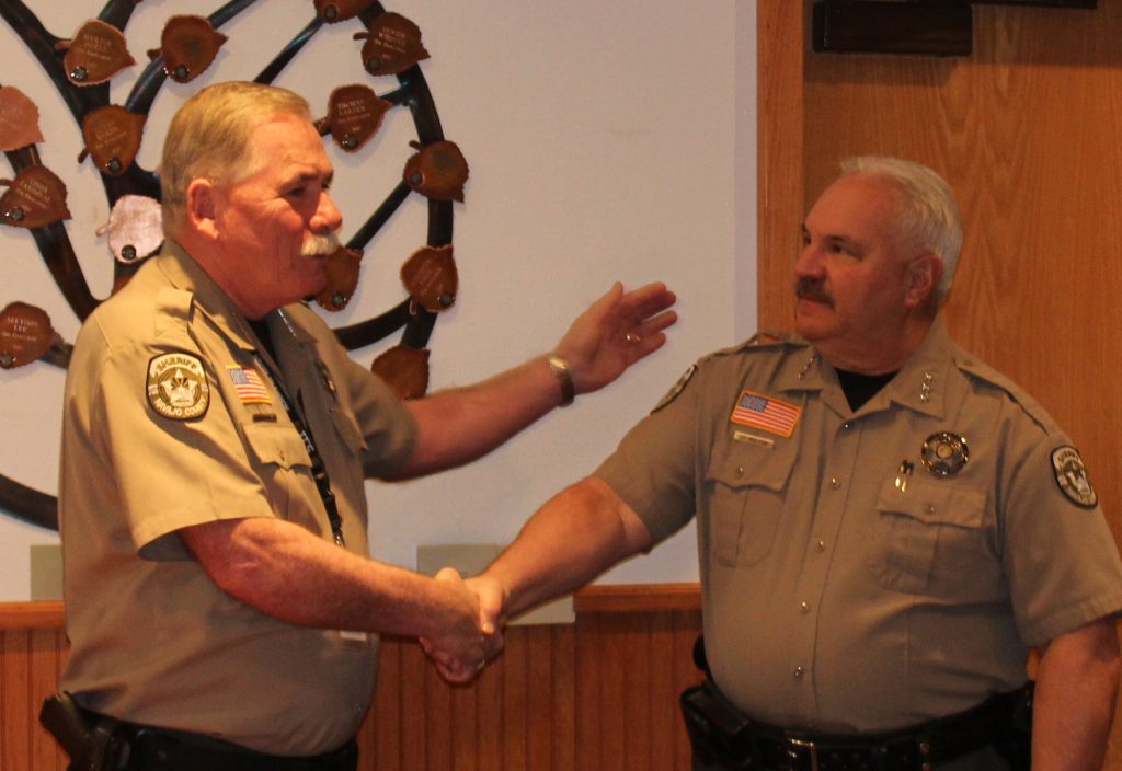 Photo by Toni GibbonsNavajo County Sheriff KC Clark (left) shakes hands with Chief Deputy James Molesa (right) during the presentation for Molesa’s upcoming retirement at the end of this month at the Navajo County Board of Supervisor’s meeting on Dec. 12. Molesa has served with the Navajo County Sheriff’s Office for the past five years. He has been in law enforcement for the last 38 years and is looking forward to retiring.