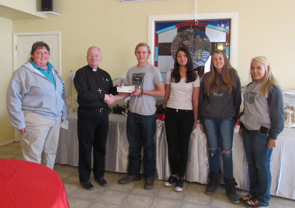 Photo courtesy of the Snowflake FFAThose present to present the FFA donation to the Farm to Football program included (left to right) Snowflake FFA Advisor Heather Scott; Father Bob Mathieu; Cody Rowell; Snowflake FFA vice president; Cecelia Alcantar-Chavez, second vice president; Elexis White, reporter; and Shayley Paz, historian.