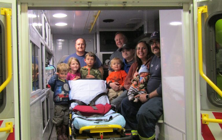Photo by Diana HutchisonMembers of the Taylor-Snowflake Fire & Medical Department recently reunited with newborn Erastus Summers and his family. They delivered the little guy in this very ambulance in the parking lot of the Taylor Fire Station on Papermill Road in Taylor on Feb. 6. Pictured are (left to right) Michael Summers, Reagan Summers, Adam Summers, paramedic Justin Kriter (behind kids), Chief William Nelson, Brandon Summers, Enoch Summers (on Dad’s lap), Laurie Summers and paramedic John Mercer holding Erastus Summers.