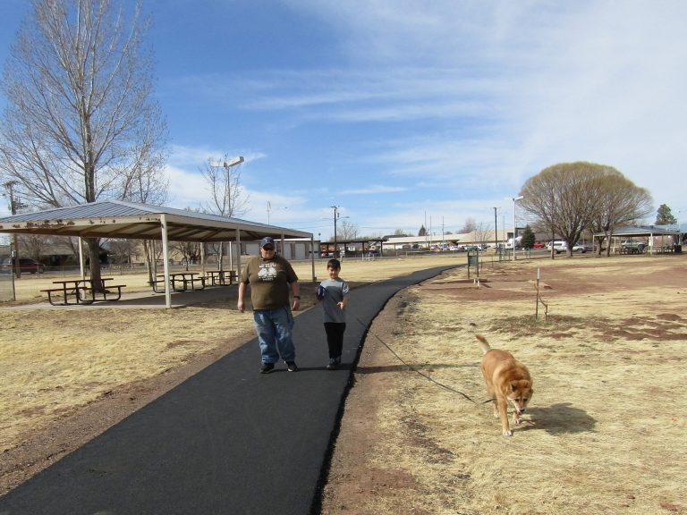 Photo by Diana HutchisonThe Town of Taylor recently re-surfaced the walking path at Freeman Park. The path is completed but the addition of rock on each side of the path still needs to be done. Donny Shurter and 8-year-old Kristin Lay took full advantage of the sunny weather and the brand new walking path while taking their dog Sasha for a walk.