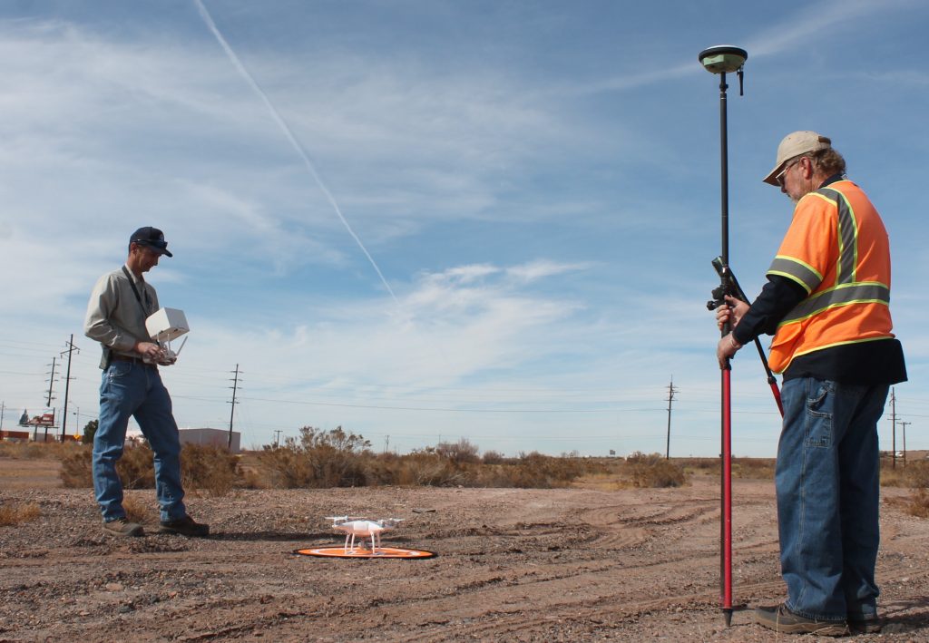 Photo by Linda KorHolbrook is getting closer to implementing its plan to develop a fishing pond at the west end of the city. Earlier this month Navajo County Engineering Project Manager Jason Owens (left) used a drone to map the topography of the site as part of the engineering preparation. Assisting with the endeavor was Navajo County Surveyor Myron Jasmann (right).