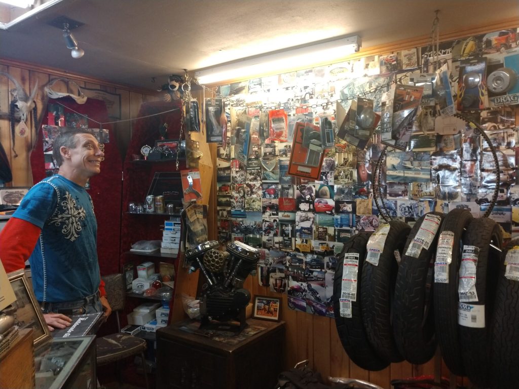 Photo by Diana HutchisonShawn “Erin” Casey of Lines-N-Signs, shares the photo covered wall of projects that he worked on with former mentor Richard Eby and hopes to continue his legacy.