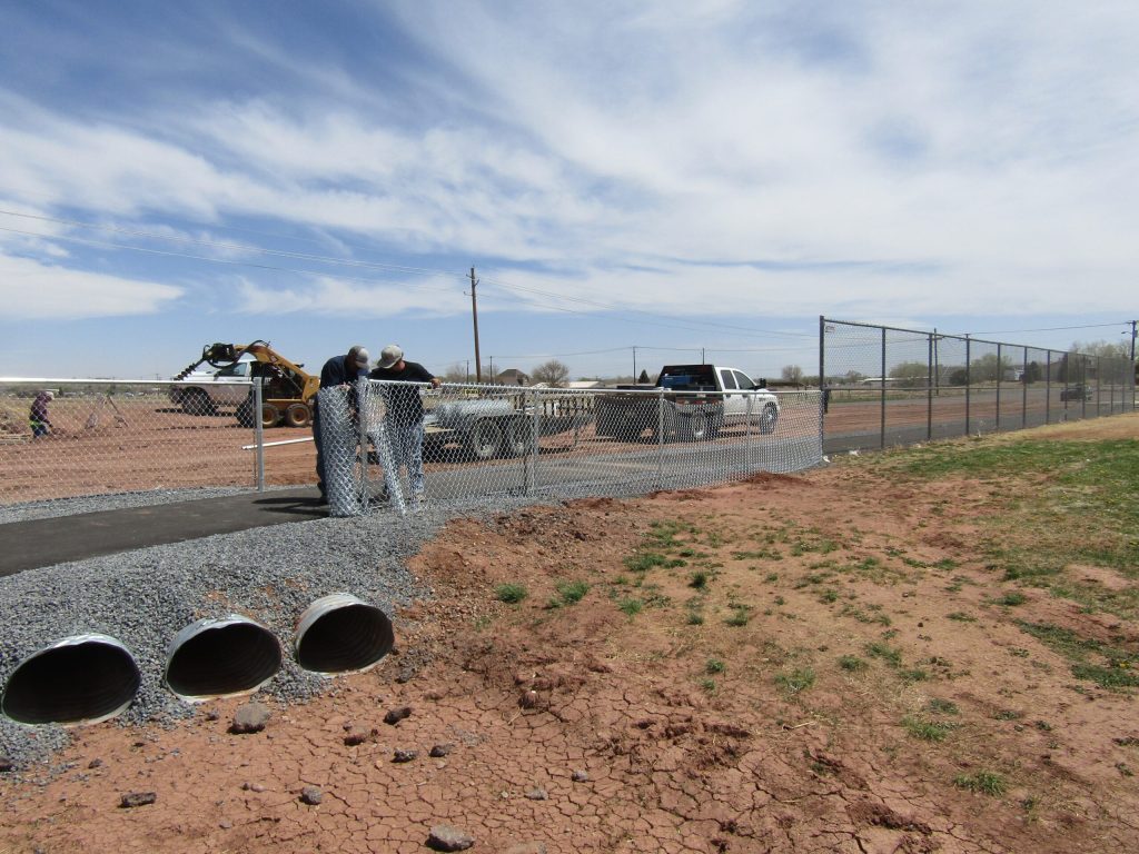 Photo by Diana HutchisonDespite the high winds, workers with Frontier Fence Company were hard at work on Thursday. They were trying to finish the new fencing for the expanded parking area near the soccer fields at Freeman Park in Taylor.
