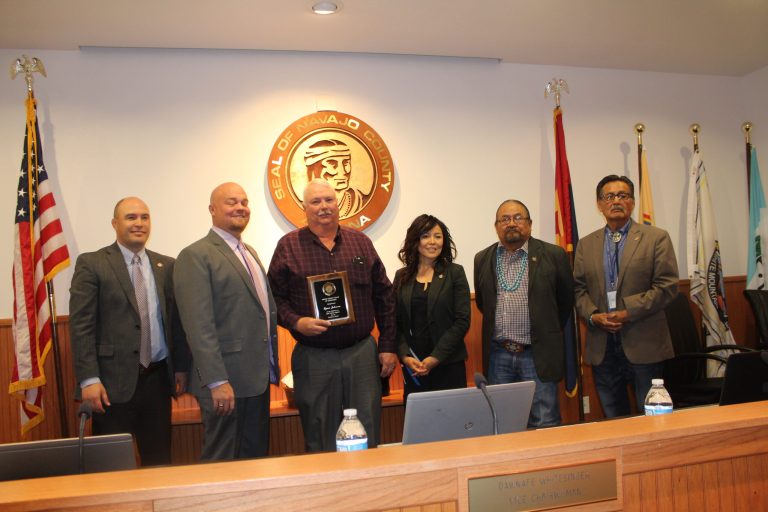 Photo by Toni GibbonsLynn Johnson receives a plaque in honor of his retirement as the Arizona Department of Transportation District Engineer for the Northeast District. Pictured are (left to right) Board of Supervisors Chairman Steve Williams, Supervisor Jason Whiting, Johnson, Vice Chairwoman Dawnafe Whitesinger, and supervisors Lee Jack, Sr., and Jesse Thompson.