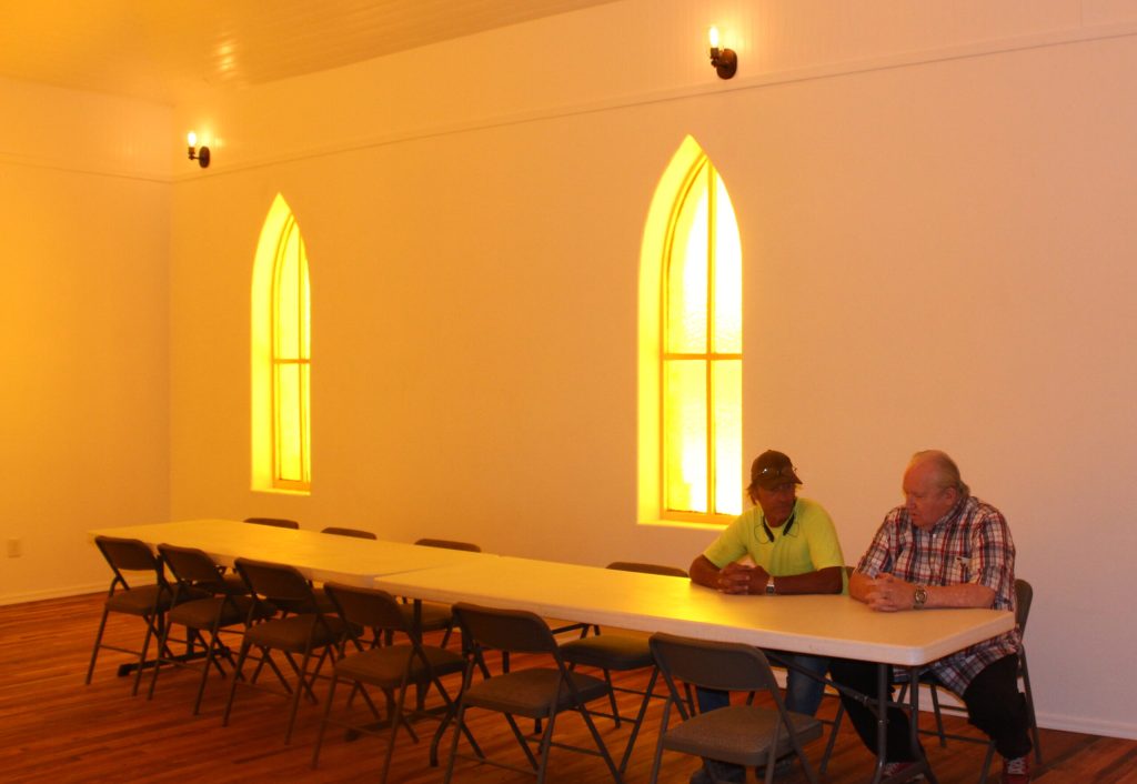 Photo by Toni GibbonsDoug Kubik (left), the building foreman for the restoration project and his brother, Pastor Jimmy Nelson, take a break in the recently restored historic Methodist Church in Holbrook.