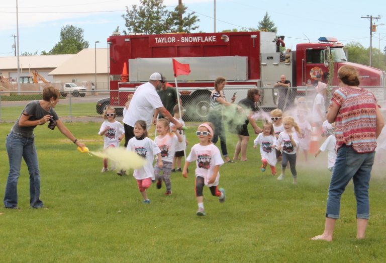 Photo by Diana HutchisonThe second annual Tint Sprint took place as part of the Trapper Days events on May 26. Runners made their way through the course as they were doused with colored powder. The littlest competitors were ages 2-6, seen here, got to take their lap first with Taylor-Snowflake Fire and Medical Department on hand to wash the color off after the race.