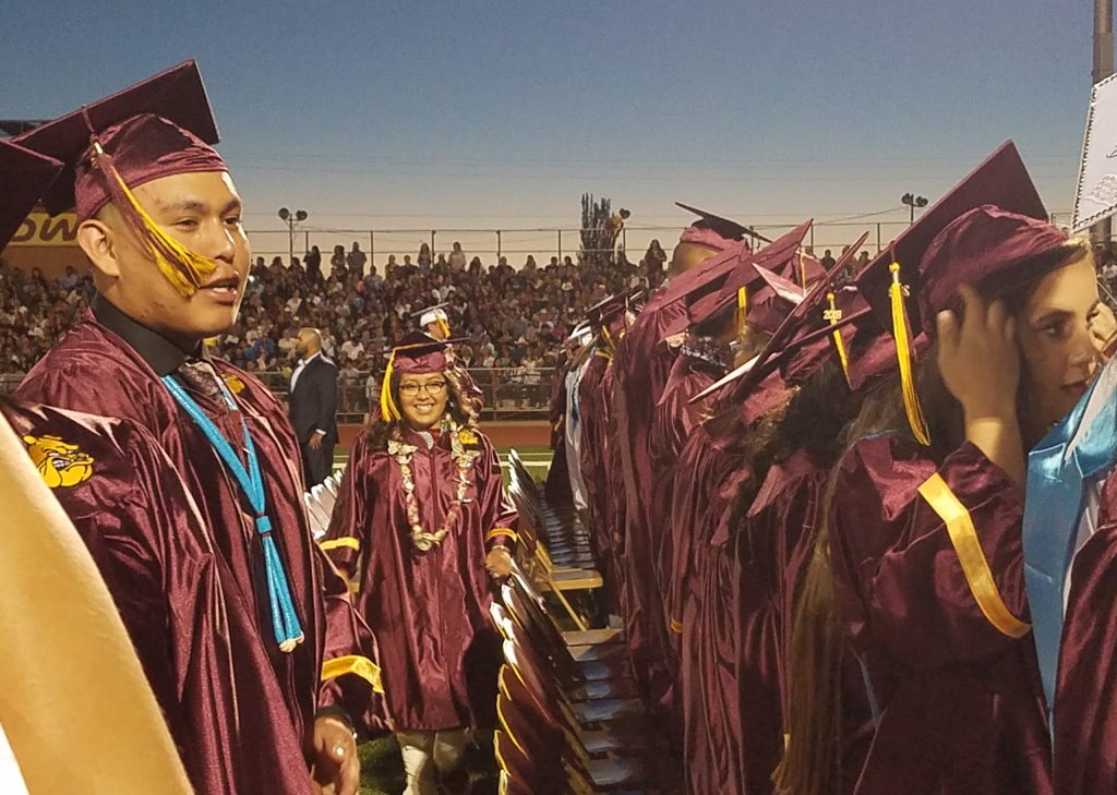 Graduate Kaylen Benito (center) is all smiles as she joins her classmate Isaac Benale (left) during last week’s ceremony.
