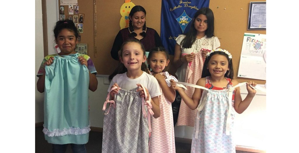 Photo by Patsy BailonMembers of the Junior Catholic Daughters of Winslow responsible for constructing dresses for less fortunate children in Africa show off their work. Pictured are (front row) Malyia Dixon, (second row from left) Trenton Alonzo, Mila Bailon, Neyeli Quintana, (back row from left) Erika Sanchez and Susie Sanchez.