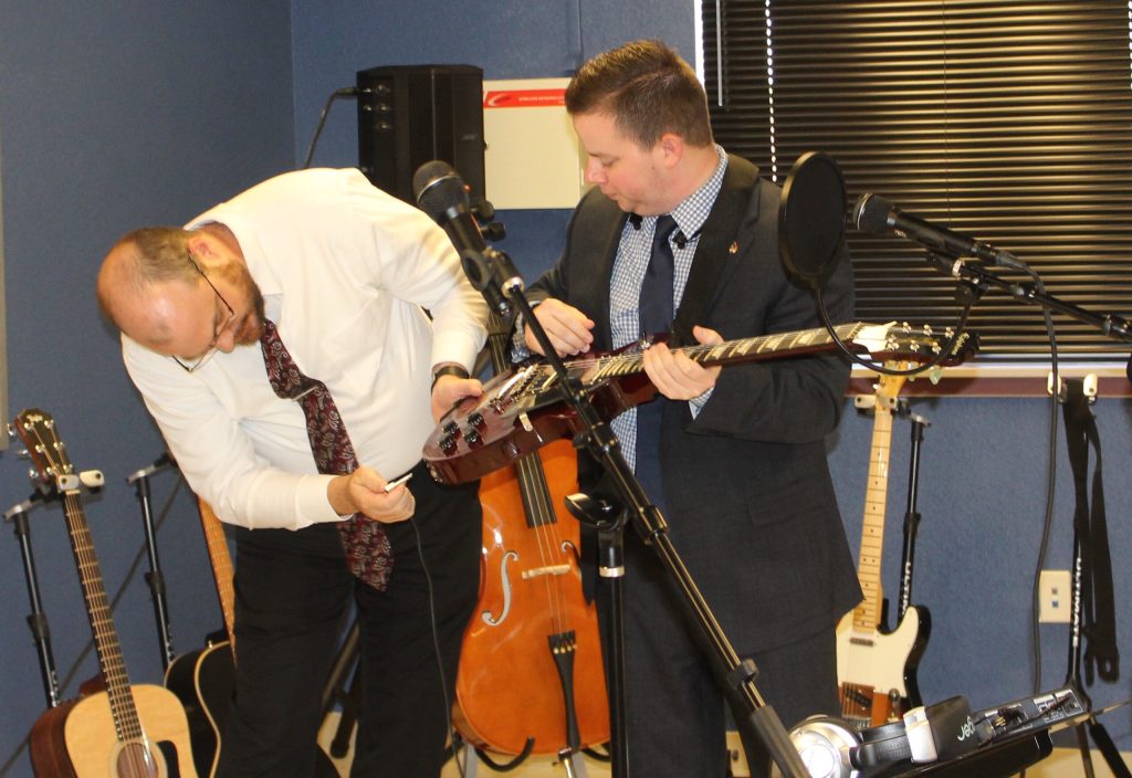 Photo by Toni GibbonsNavajo County Chief Probation Officer Jason Cash (left) and Government Relations Director Adam Wolfe (right) take a moment to try their hands with the newly purchased music equipment at the H.U.B. Center for Success.