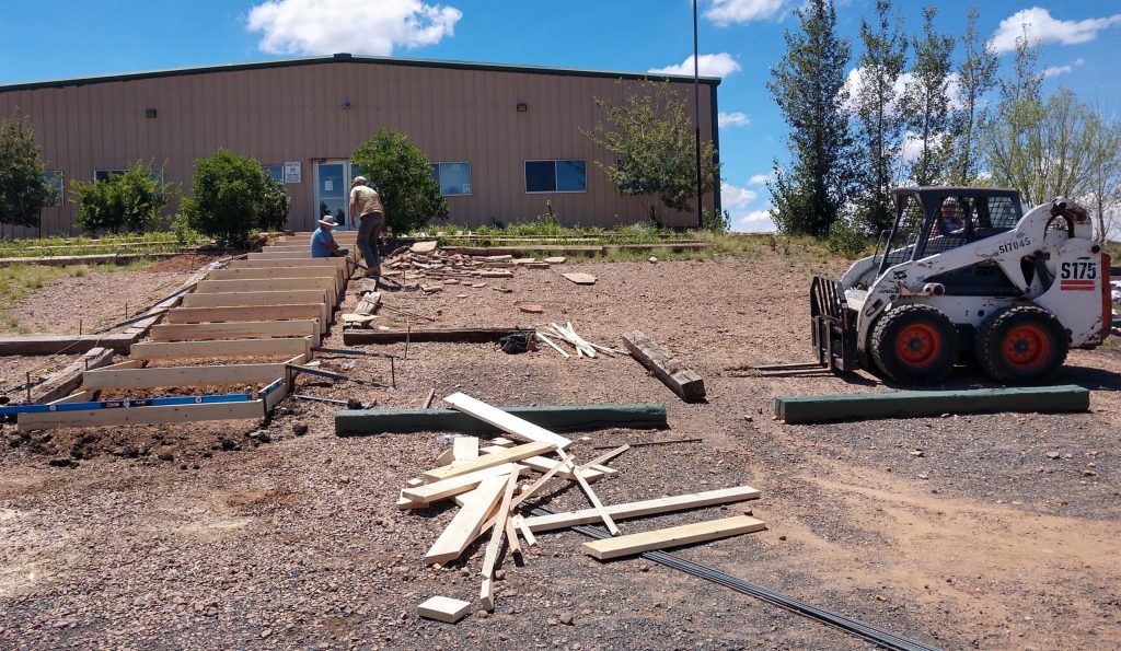 Photo by Diana HutchisonNorthern Arizona Academy, a charter high school in Taylor, is getting a brand new concrete walkway in time for the new school year. Last week, workers with Spires Concrete Worx were busy building the forms to get ready for the concrete. The new steps will be much safer and more attractive than the old railroad ties.