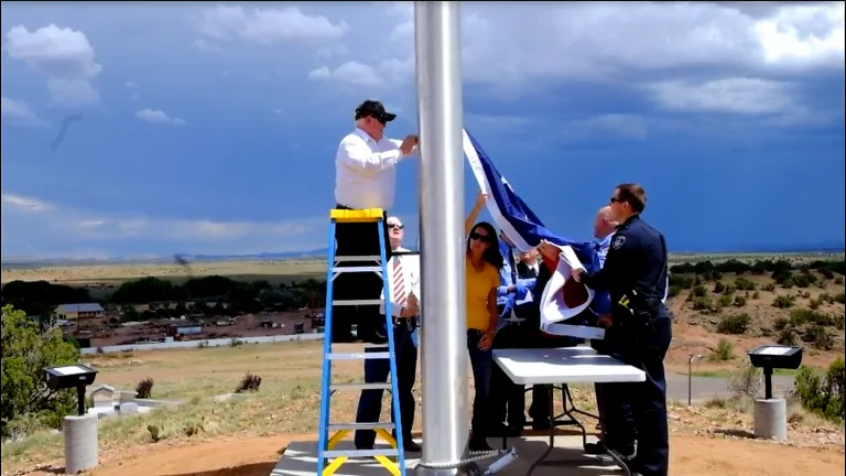 Photos courtesy of the Town of SnowflakeLocal Vietnam War veteran Tim Sears (standing on the ladder) had the honor of raising the American flag on the recently installed 80-foot flagpole that overlooks Snowflake with some assistance from Snowflake councilmembers, members of the police department and Taylor Snowflake Fire & Medical Department. The flag is proudly displayed on the hill by the Snowflake Junior High School football field located on Main Street.