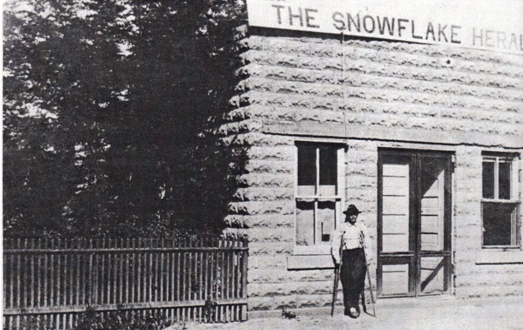 Photo from the book ‘From Indian Trails to Jet Trails’The Snowflake Herald had its start in this block building in 1913. Pictured is the editor at the time “Deacon” Jones.