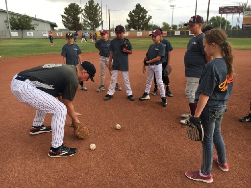 Photo courtesy of APS staffFormer Major League Baseball Player Ken Phelps (left) demonstrates fielding to the kids who participated in the Arizona Public Service (APS) All-Star Clinic at Winslow’s Little League Field on July 23.