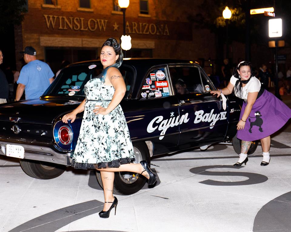 Photo by Randall SahmieMembers of the Cherry Bombs took part in the sock hop and other events held during A Midsummers Day in Winslow last weekend. Pictured here are Alexx Kennedy (left) and Sarah Medina (right) posing with a car owned by Guillermo Mendoza.