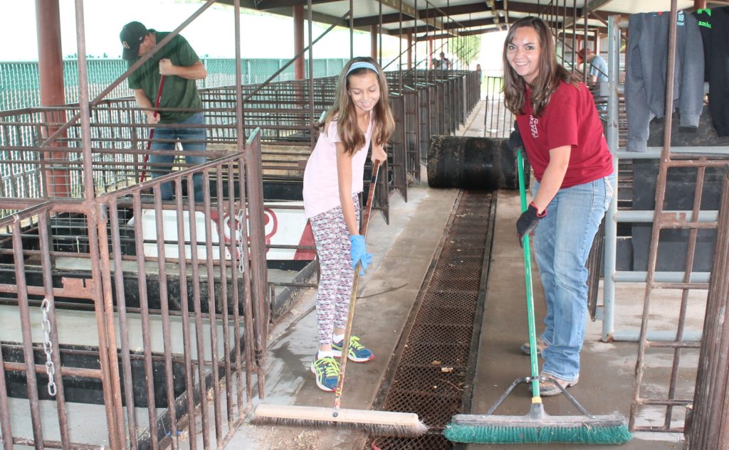 Photo by Linda KorThe Navajo County Fair is just a couple of weeks away and that means a lot of hard work leading up to the annual event that brings thousands of people to the City of Holbrook. Here Stephanie Westover (second from right) and her daughter Lana (second from left) take their Saturday along with Stephanie’s husband Tim (left) and son Austin (right) to clean up the livestock barn at the fairgrounds.