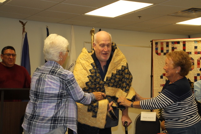 Photo by David C. SchneiderThomas Meyer Jr., a Taylor resident who served in the Air Force from 1972-1979, was wrapped in a Quilt of Valor by Carol Schilling (left) and Diana Vance (right) at the awards ceremony hosted by Heart 2 Heart Quilts and Snowflake’s American Legion Post 126.