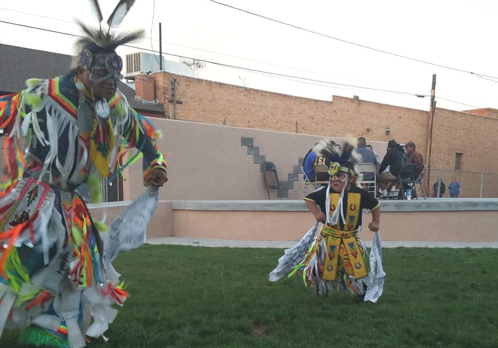 Photo by L. ParsonsYoung Navajo dancers like 4-year-old Zachary Francis (right) learn the drum and dance traditions from their older relatives. Here, little Zachary dances with his uncle while the Standing Horse Singers share their music.