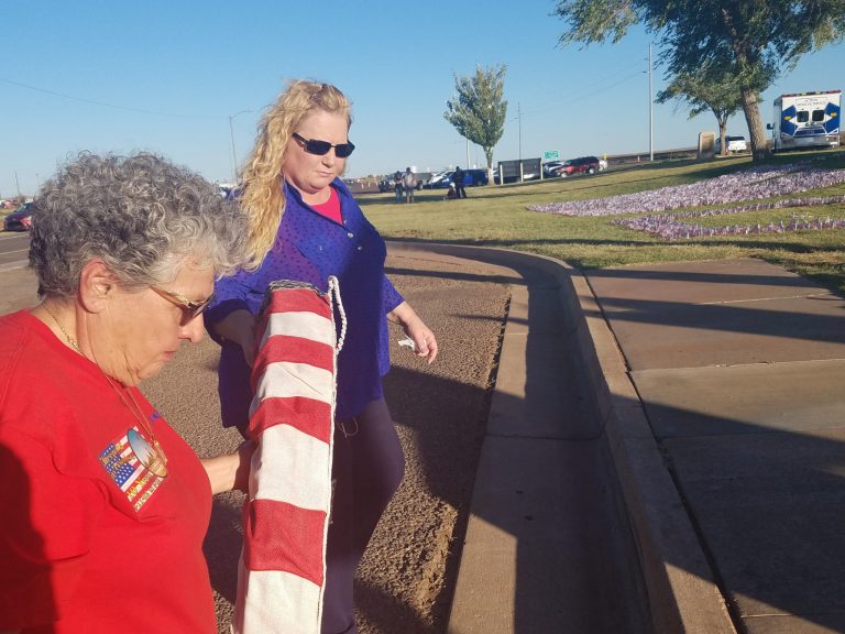 Photo by L. ParsonsWinslow citizens came together last week to remember the lives lost in the grisly attacks on Sept. 11, 2001. Speakers at the memorial included Mayor Tom McCauley and United States Congressman Tom O’Halleran. Here, Lani White (right) and Dee Rodriguez (left) lay the traditional remembrance wreath in the shadow of the pieces of the World Trade Center that stand in Winslow’s Remembrance Garden.