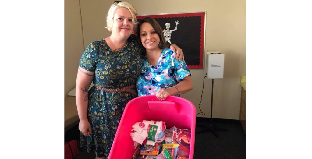 Photos courtesy of The Cherry BombsThe Cherry Bombs school supply drive included helping with hygiene items, extra underwear and cleaning supplies. Bonnie Brennan Elementary School Health Technician Mica Vasquez (right) was grateful to receive the help from Cherry Bomb President, Lauralee Parsons (left).