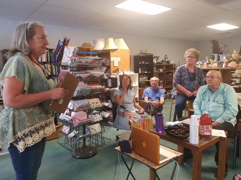 Photo by L. ParsonsMichelle Lytle of RSVP (standing) spoke to a group of senior citizen volunteers at an application event hosted by Alice’s Place in Winslow. Those attending included (left to right) Denni O’Quinn, John Mead, Toya Rubi and Jeff Patton.