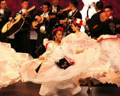 Photo courtesy of Desierto de ColoresAmid the swirling of dancers, Alexa Quezada (center), with the Holbrook Desierto de Colores Ballet Folklorico, wearing the traditional Jalisco-style dress, dances to the beat of the live Mariachi music at Mariachi and Folklorico Festival.