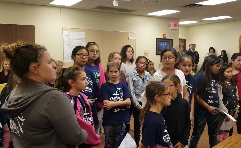 Photo by L. ParsonsGirls on the Run coach Taylor Bradley (left) along with many of the girls from the group addressed the Winslow School District Governing Board at their latest meeting.