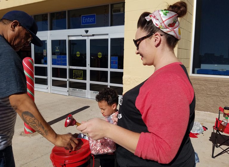Photo by L. ParsonsJami McPherson (right) a member of the local charity group The Cherry Bombs and her son Trace (center) rang the bell for the Salvation Army on Saturday. The funds raised help Winslow residents during times of need.