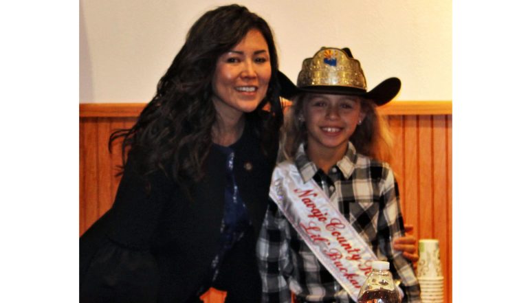 Photo by Toni GibbonsVice Chairwoman Dawnafe Whitesinger (left) gave Navajo County Fair Little Buckaroo Queen Lily Moreno (right) a hug after crowning her.