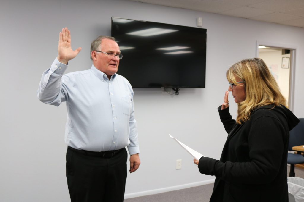 Photo by Linda KorHolbrook Councilman Mike Nilsson (left) was sworn into office on Dec. 4, by Holbrook Administrative Assistant Lisa Maestas (right) making it a full council as the members move forward this week in consideration of candidates for a new city manager.