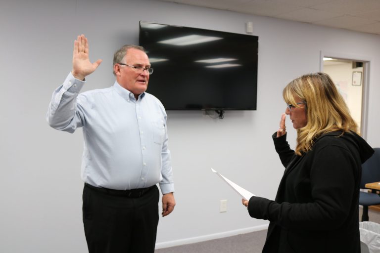 Photo by Linda KorHolbrook Councilman Mike Nilsson (left) was sworn into office on Dec. 4, by Holbrook Administrative Assistant Lisa Maestas (right) making it a full council as the members move forward this week in consideration of candidates for a new city manager.