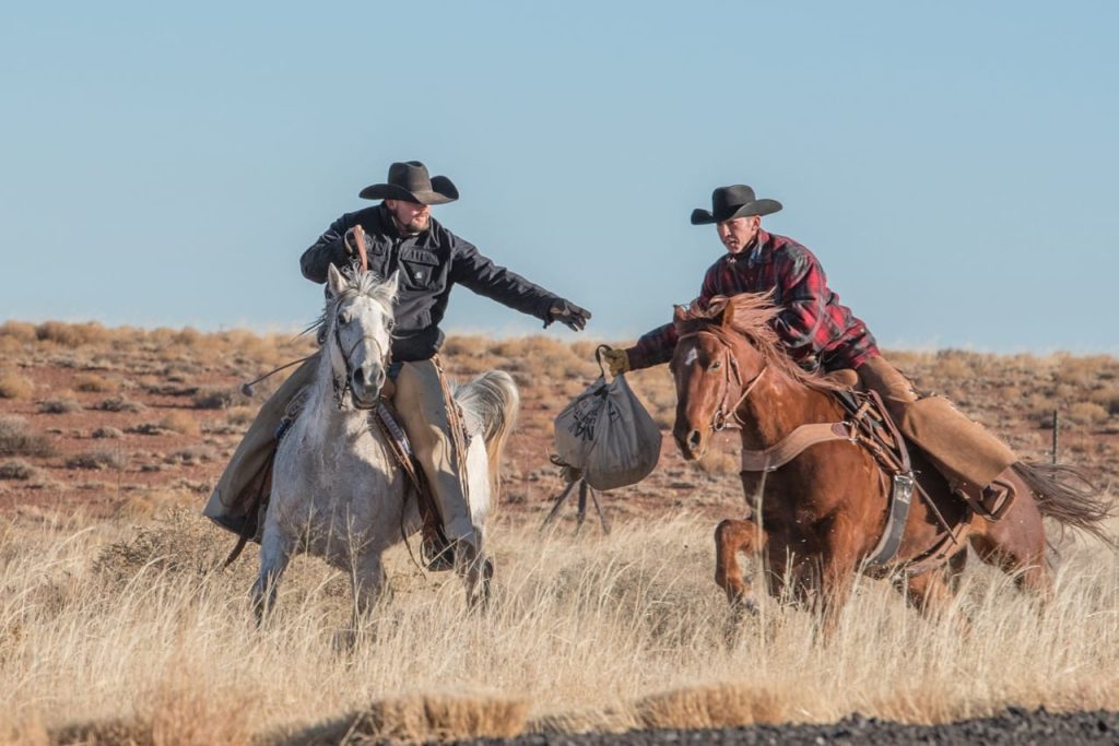 Photo courtesy of Hashknife PosseRiders of the Hashknife Pony Express hand off the mail bag during the 2018 Hashknife Pony Express Ride.