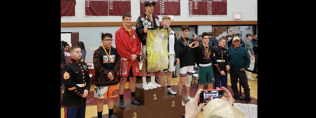 Photo courtesy of Tess DunsmoreWinslow Bulldog Michael Dunsmore (center) was the lone local champion Jan. 18-19 at the Doc Wright Invitational Wrestling Meet in the 170 lb. class.