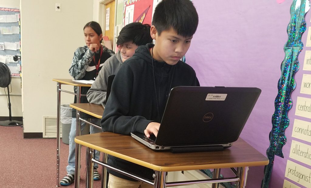 Photo by L. ParsonsSeventh grade language arts students Alex Yazzie (front), Adam Padilla (center) and Daiven Ownspipe (back) stand at their new desks in Samantha Monroe’s classroom.