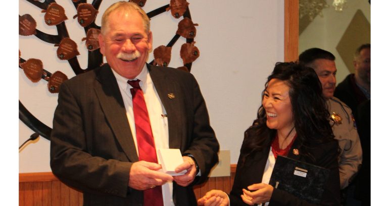 Photo by Toni GibbonsNavajo County Chairwoman Dawnafe Whitesinger (right) presents retiring Sheriff KC Clark (left) with a plaque of appreciation and a special ring made for him at the Feb. 12 meeting.