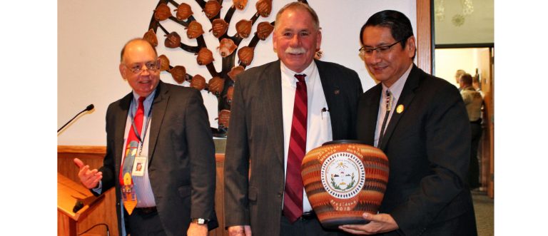 Photo by Toni GibbonsAs the Navajo County Board of Supervisor’s honored Sheriff KC Clark (center) as he retires from office, Clark and County Attorney Brad Carlyon (left) took a moment to honor their friendship with Navajo Nation President Jonathan Nez (right) giving him a specially made Navajo pot honoring Nez’s time as county supervisor from 2009 to 2015 and now the president of the Navajo Nation.