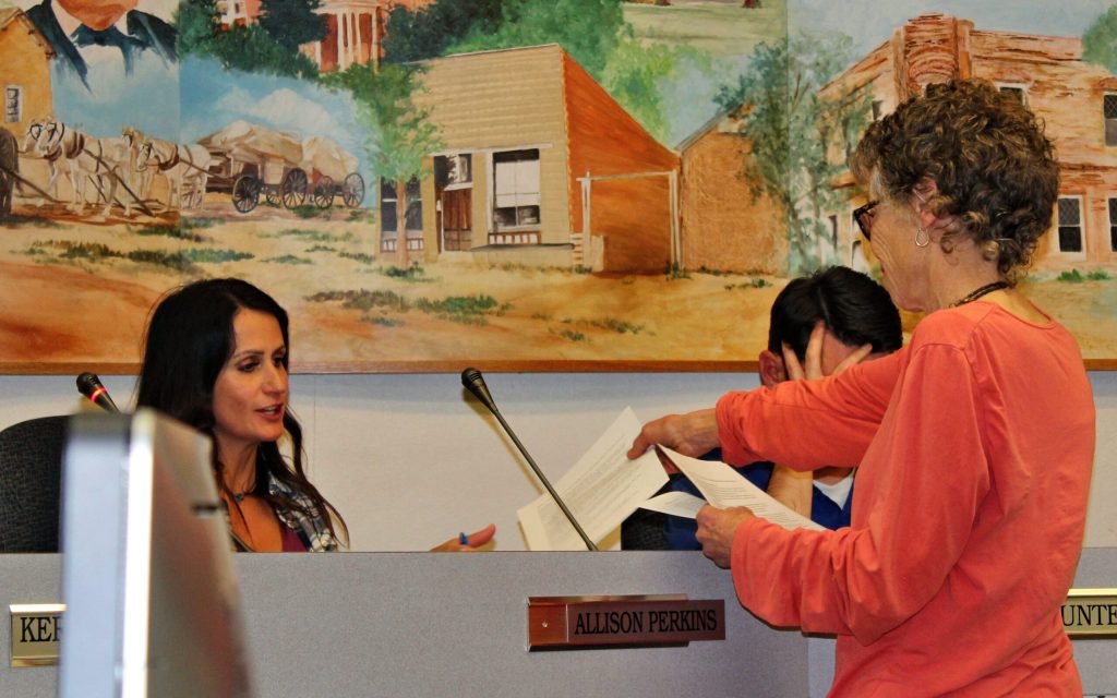 Photo by Toni GibbonsSusan Molloy, a resident who lives east of Snowflake, handed out information on the dangers of 5G, as well as electromagnetic radio devices to the Councilwoman Allison Perkins (left) during the Snowflake Town Council meeting on March 5.