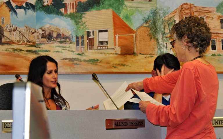 Photo by Toni GibbonsSusan Molloy, a resident who lives east of Snowflake, handed out information on the dangers of 5G, as well as electromagnetic radio devices to the Councilwoman Allison Perkins (left) during the Snowflake Town Council meeting on March 5.