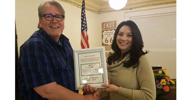 Photos by L. ParsonsChamber of Commerce CEO Bob Hall (left) presented Elana Chacon of Joe’s Glass (right) with a certificate signifying her as a board member of the Winslow Chamber last week.