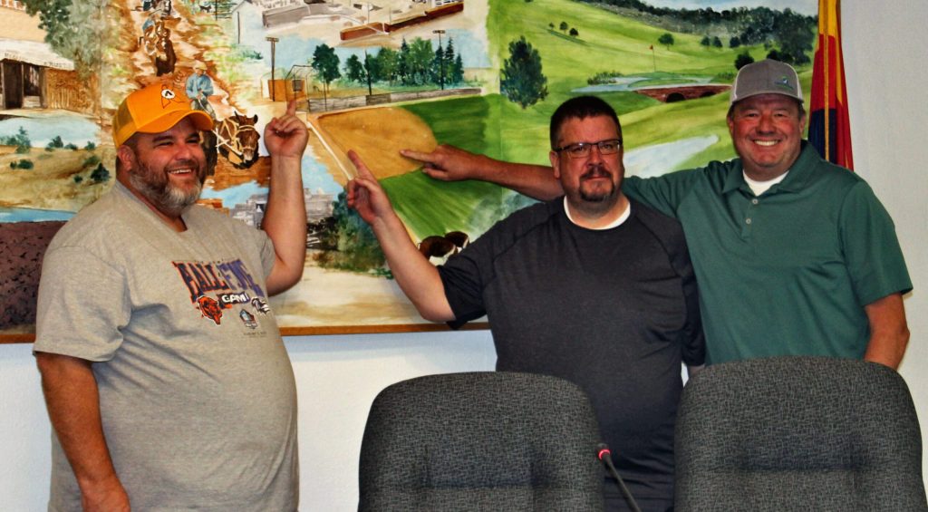 Photo by Toni GibbonsAfter requesting that the ball field in Fredrickson Park be named in honor of their father Blaine Jarvis, the Jarvis brothers (left to right) Mitch, Kelly and Lou, point out the ball field in the Snowflake council room mural that was such a part of all their lives at the Snowflake Town Council meeting on April 2.