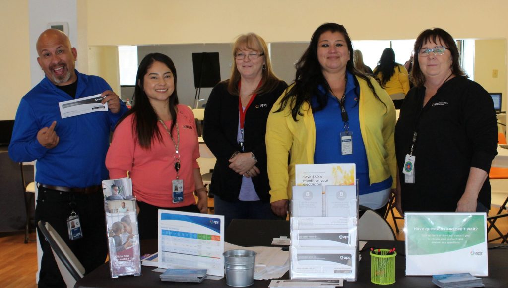 Photo by Toni GibbonsArizona Public Service (APS) staff members set up shop at the Machusak Recreational Center in Holbrook on April 24 to educate customers, especially those in need, about the assistance programs and energy-saving options available through APS. Pictured are (left to right) Team Lead John Ruiz, call center advisors Maria Lopez, Prisicilla Brockman and Marissa Morales, and Community Affairs Manager Janet Dean.