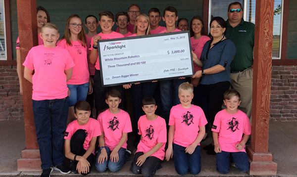 Photo courtesy of Cable OneOn May 15, Cable One presented a check for $3,000 to White Mountain Robotics (WMR) at the Taylor Town Hall. Pictured are (front row, left to right) Geoff Foutz, Jesse Rowles, Gideon Rowles, Gabe Johnson, Clay Chapman, (back row) Coach Jennifer Brimhall, Blake Johnson, Ella Willis, Susannah Rowles, Brylan Clark, Zak Foutz, Coach Jason Johnson, Kaitlyn Johnson, Bryce Johnson, Gideon Brimhall, Coach Heather Johnson, Katie Brimhall, Cable One Lead customer service representative for Northern Arizona Karlee Garcia and Cable ONE technical operations manager in Northern Arizona Derrick Hallman. Not pictured is Coach Dan Rowles.