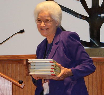Photo by Toni GibbonsNavajo County Library District Director Geneva Durkee (pictured) passed out books to the Board of Supervisors before beginning her presentation at the May 28 meeting.