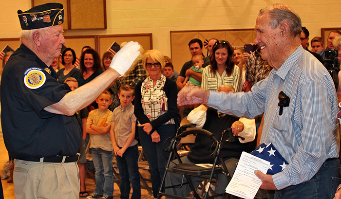 Photo by Toni GibbonsSnowflake-Taylor American Legion Chaplain David Larson presented the flag that had flown over the Taylor Veteran’s Memorial for the past year to Sam Daniels, a Taylor resident who served in the Navy during the Korean War, at the Trapper Days Memorial Day service on May 25.