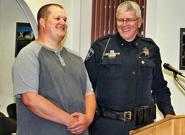 Photo by Toni GibbonsSnowflake-Taylor Police Chief Larry Scarber (right) takes a moment to share some of the stories about retiring Officer Brandon Gardner (left) at the Snowflake Town Council meeting on June 4.